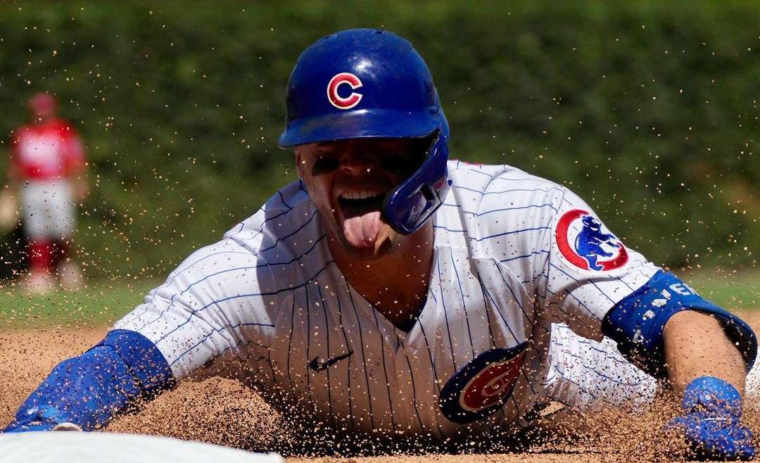 Chicago Cubs Offseason 2023 post featured image of Nico Hoerner sliding into 3rd base.