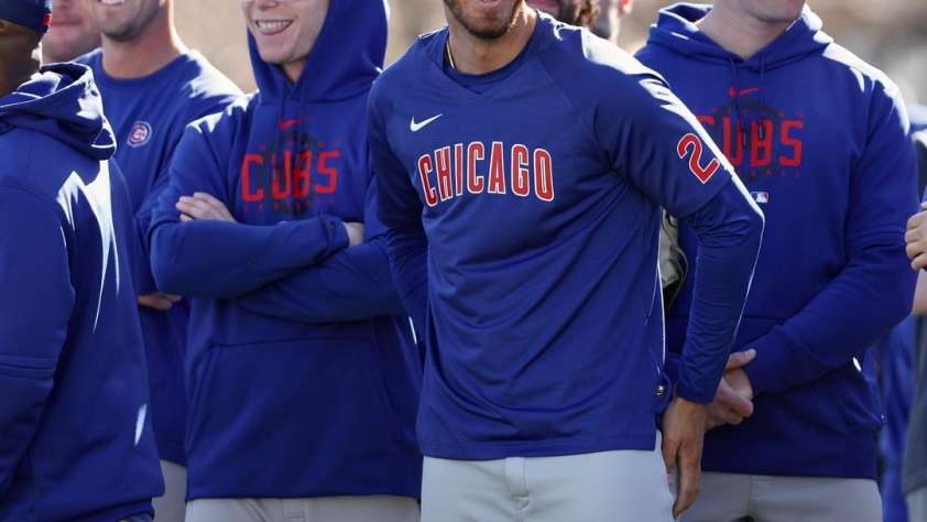 Featured image for 2023 Spring Training post of Cubs players smiling during a practice.