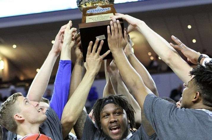 Purdue Men's Basketball team hoisting the Big Ten tournament trophy in 2023.