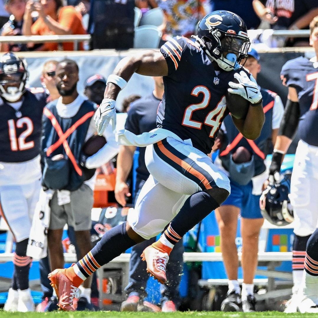 Featured image for the sports fan travel survey blog of Chicago Bears running back Khalil Herbert carrying the football.