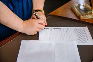 Woman signing insurance paper