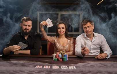 3 people sitting at a poker table