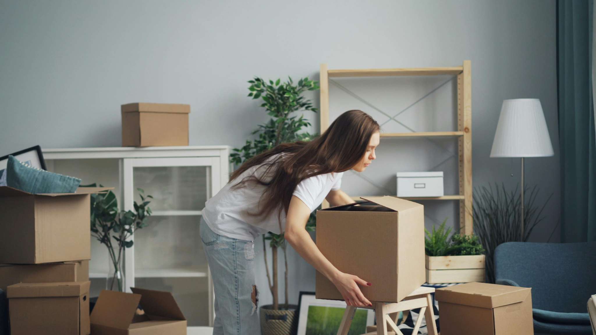 Woman lifting moving box