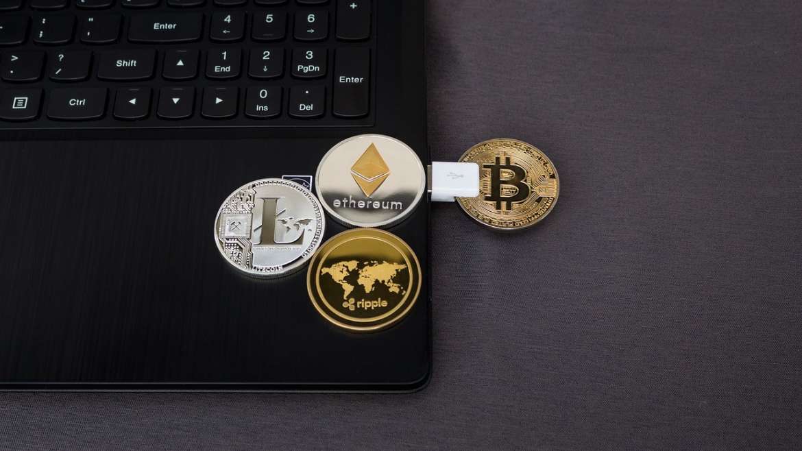 Bitcoin and other crypto coins on a laptop