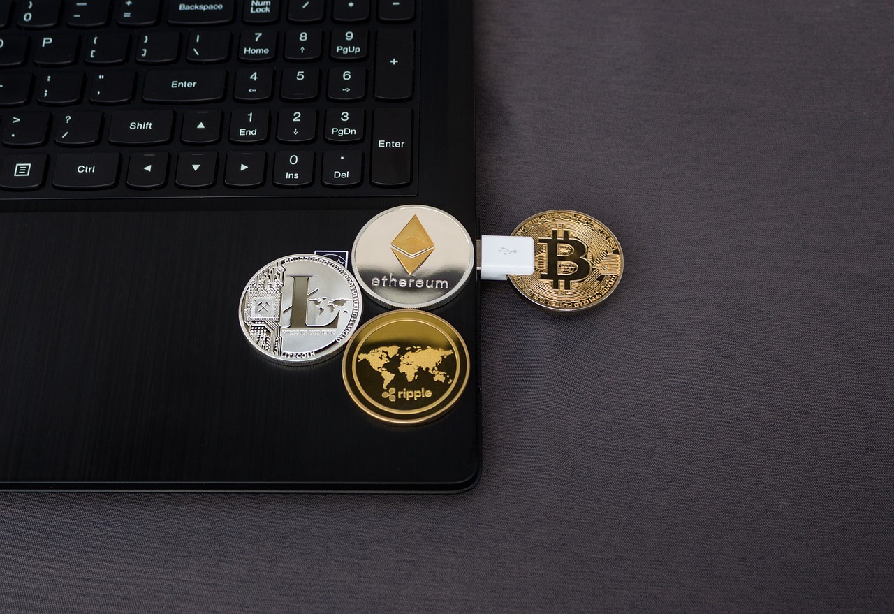 Bitcoin and other crypto coins on a laptop