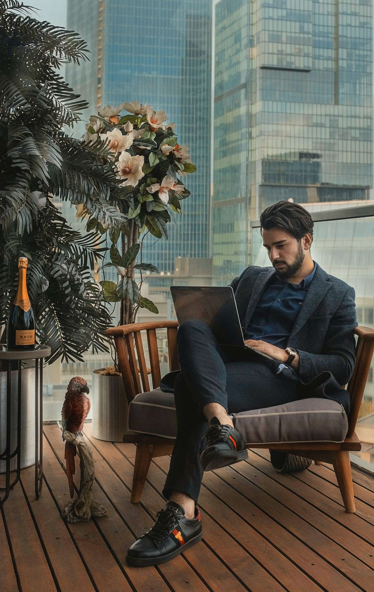 Man sitting in chair with laptop on his lap