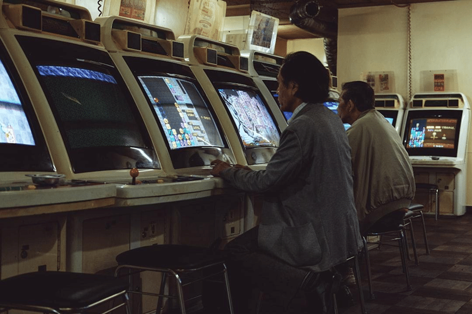 Man in a public gaming hall in front of a computer