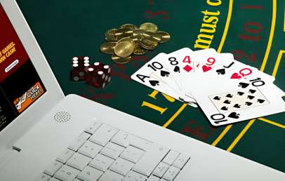 Poker cards and Laptop on table