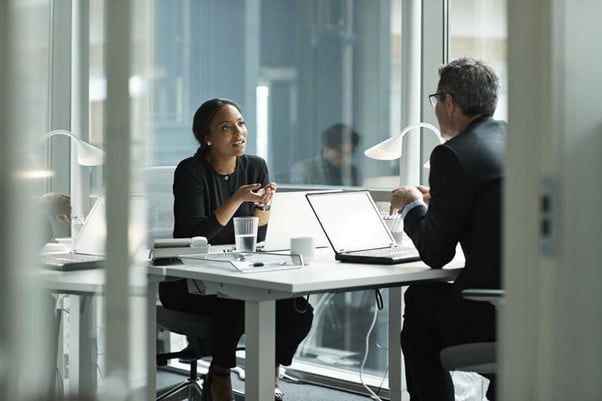 Two people talking in office