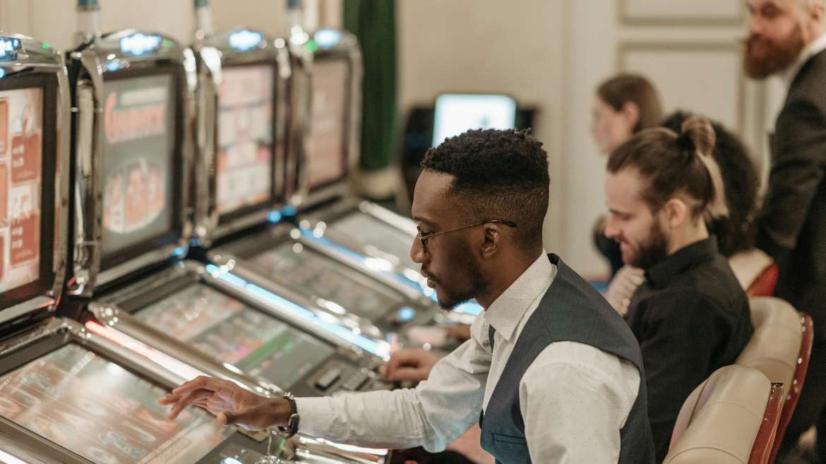 Man Playing Slots in a Urban Casino