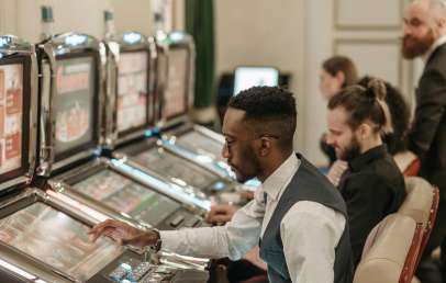 Man Playing Slots in a Urban Casino