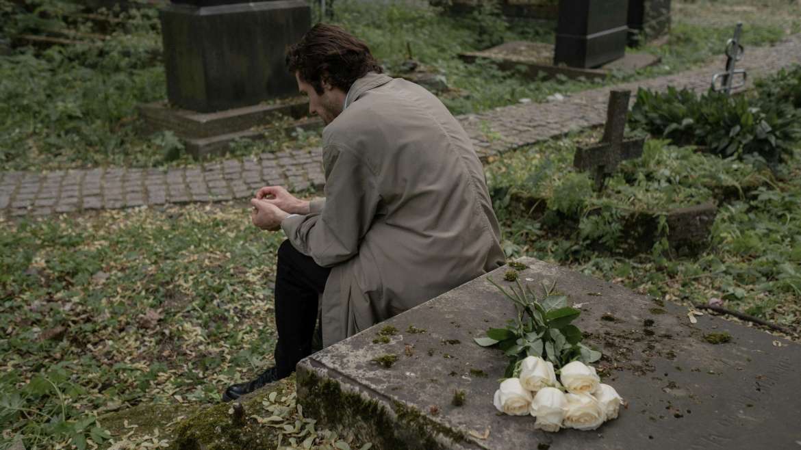 Man sitting at grave