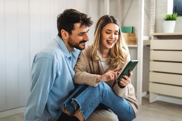 Couple searching for flight on phone