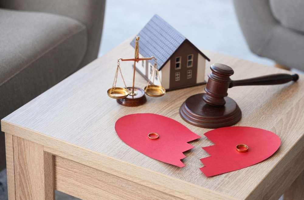 Broken heart house and scale on the table