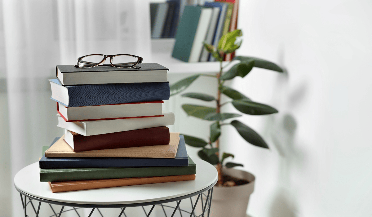 Stack of books with glasses on a table representing recommended reading on South Korea–Japan tensions, including history, politics, and alternative perspectives